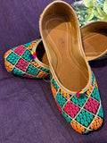 Multicolor Phulkari Embroidered Punjabi Jutti – Handcrafted Ethnic Footwear with Vibrant Threadwork & Pom-Pom Detailing