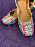 Multicolor Thread Embroidered Punjabi Jutti – Handcrafted Ethnic Footwear with Striped Design & Pom-Pom Detailing