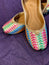 Multicolor Thread Embroidered Punjabi Jutti – Handcrafted Ethnic Footwear with Striped Design & Pom-Pom Detailing