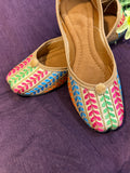 Multicolor Thread Embroidered Punjabi Jutti – Handcrafted Ethnic Footwear with Striped Design & Pom-Pom Detailing